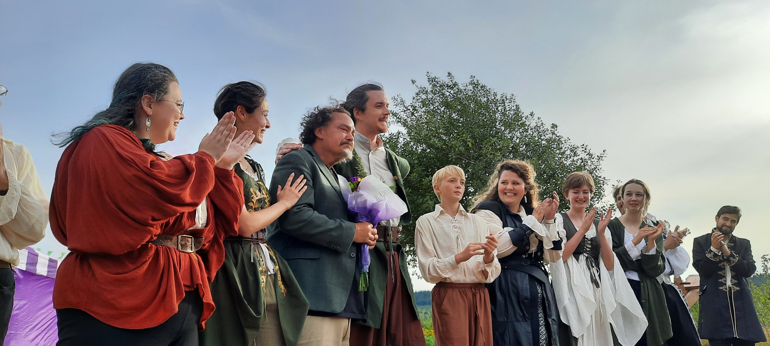 The cast presents director Erik Van Beuzekom with a bouquet on opening night of Sherwood: The Adventures of Robin Hood. Photo by Kathie Meyer