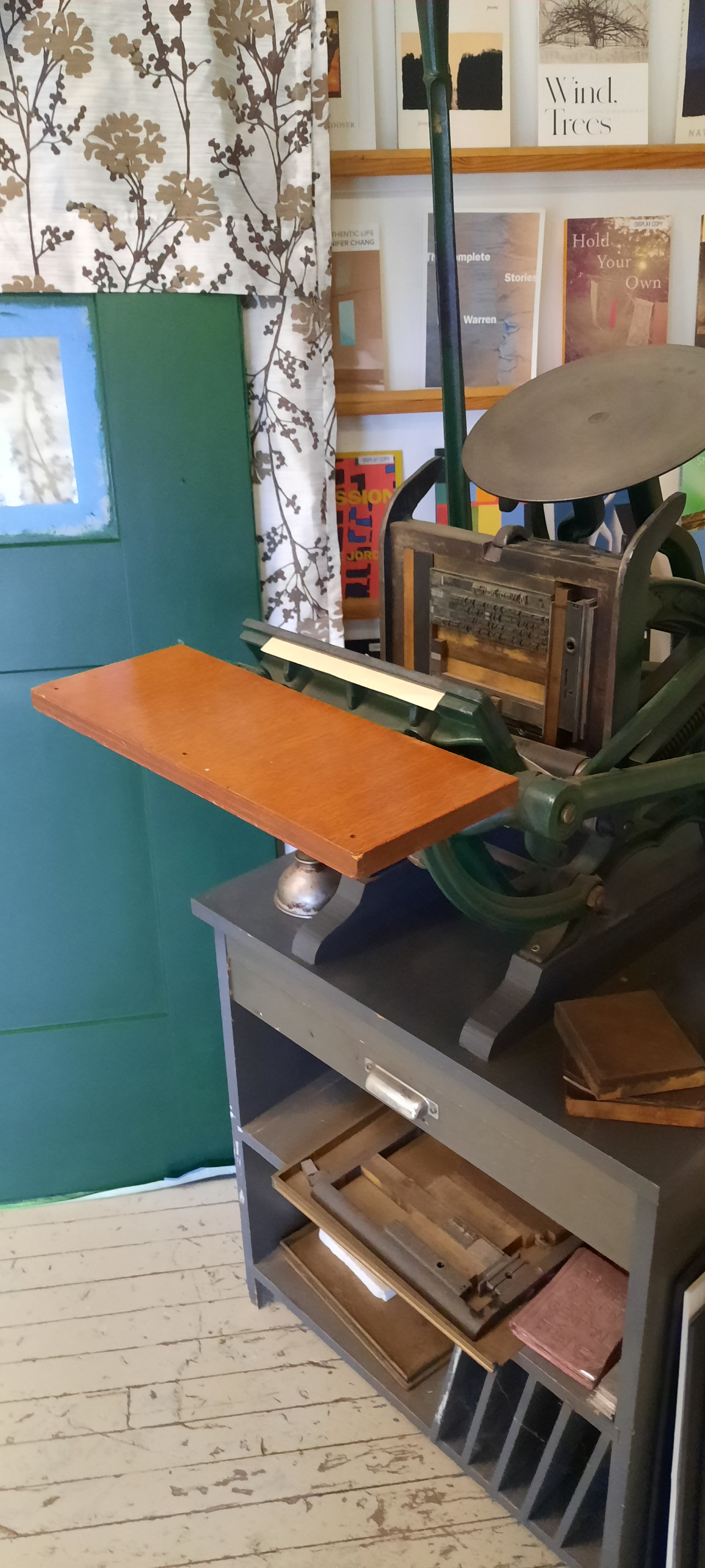   A small letterpress printer is on display next to a new door ready for installation at Copper Canyon Press. Photo by Kathie Meyer  