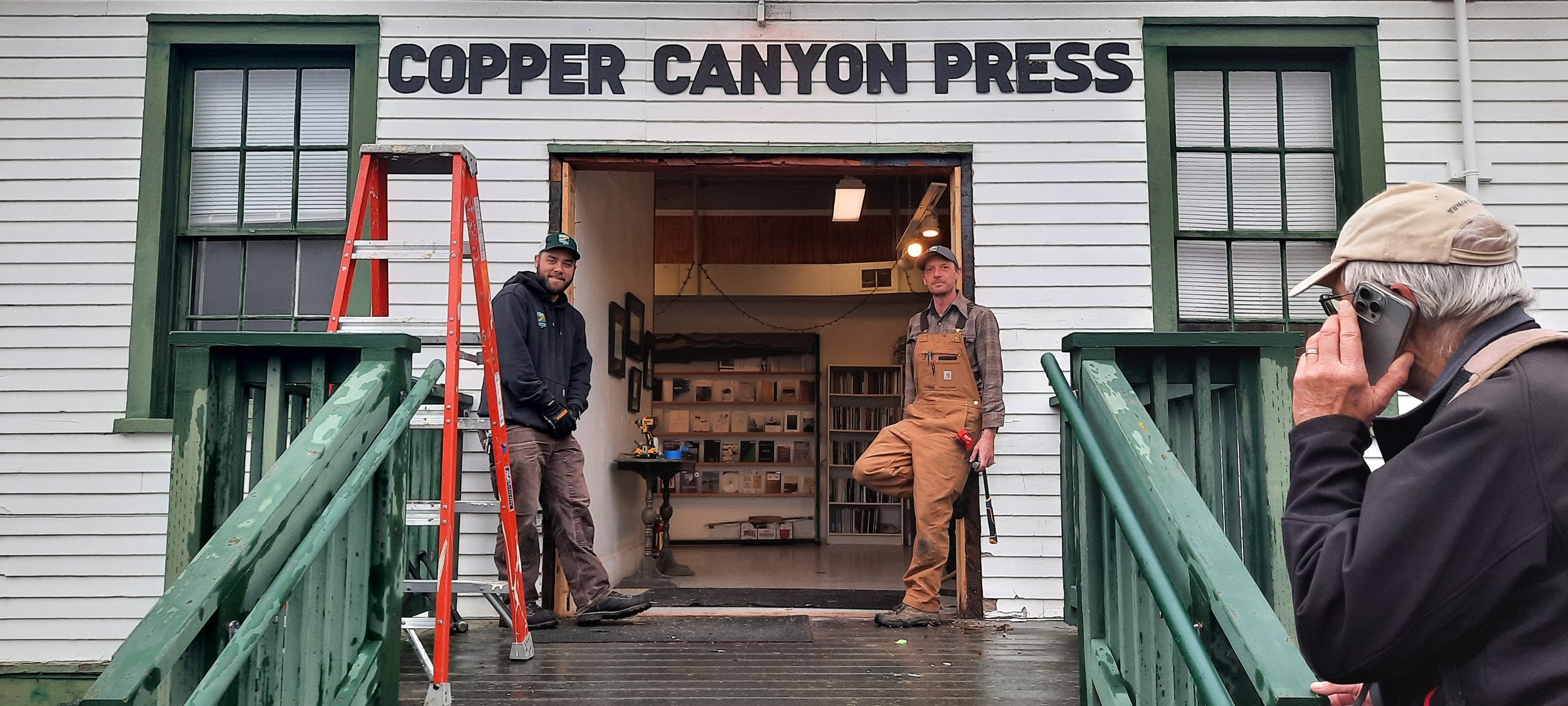   On Monday, Dec. 8, Copper Canyon Press's doors were replaced with new ones by Centrum's Jim Guthrie (far right), and parks employees Eli Lederer (left) and Chris Guile (right). Guthrie said the state had the final say in the door's design. Photo by Kathie Meyer  