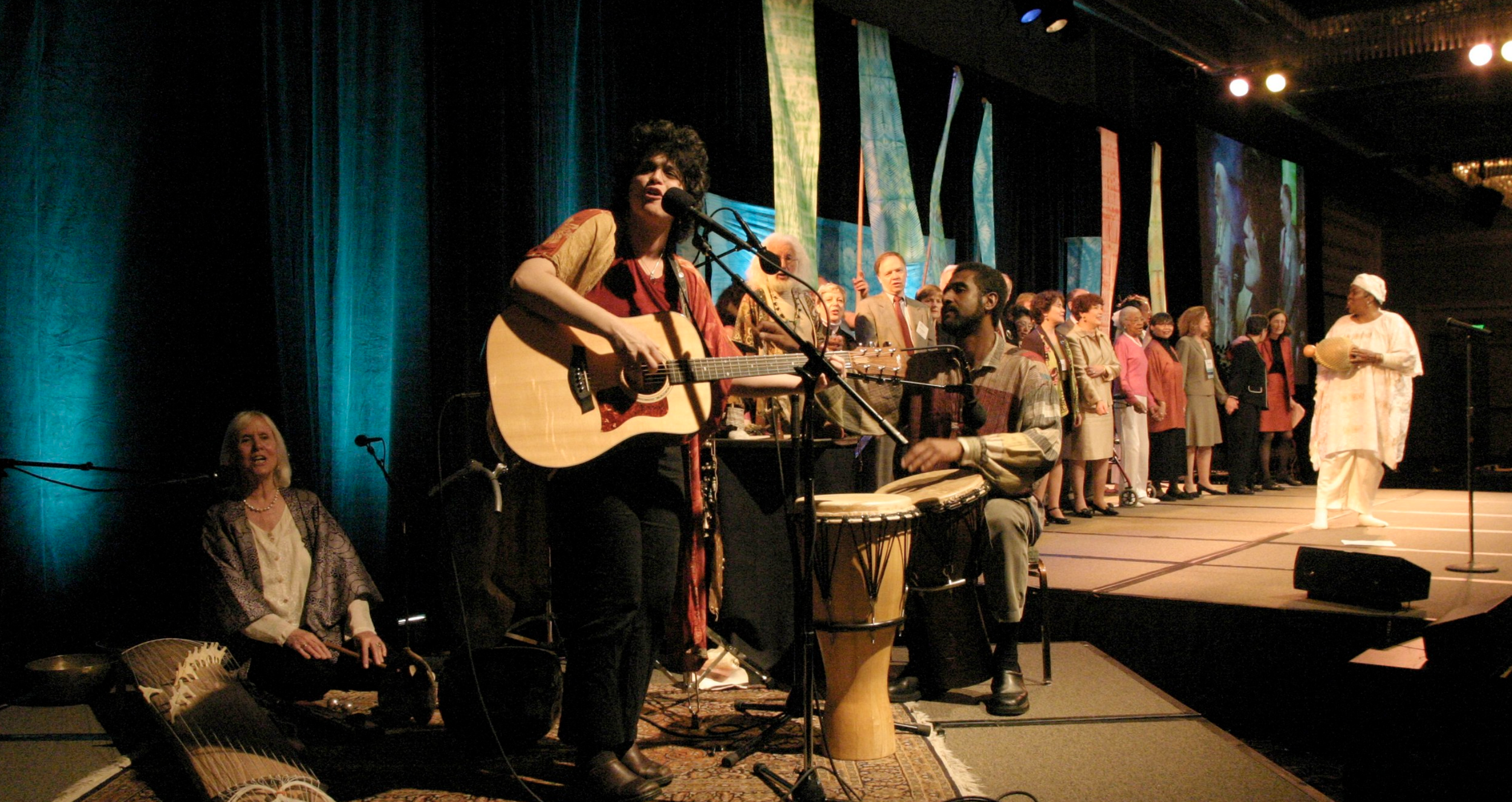   Judith-Kate Friedman stands singing with her guitar at the Aging in America conference in 2004.    Gary Wagner Photo   