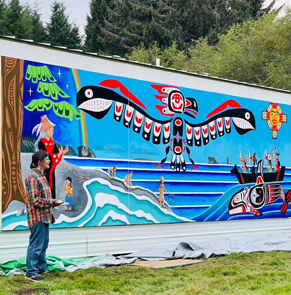   Danielle Fodor stands next to the mural she helped create in conjunction with members of the Hoh Tribe. Fodor has been painting murals for over 20 years but only recently brought those skills to the New Old Time Chautauqua on her second tour with the troupe. All photos courtesy of Jo Blair  
