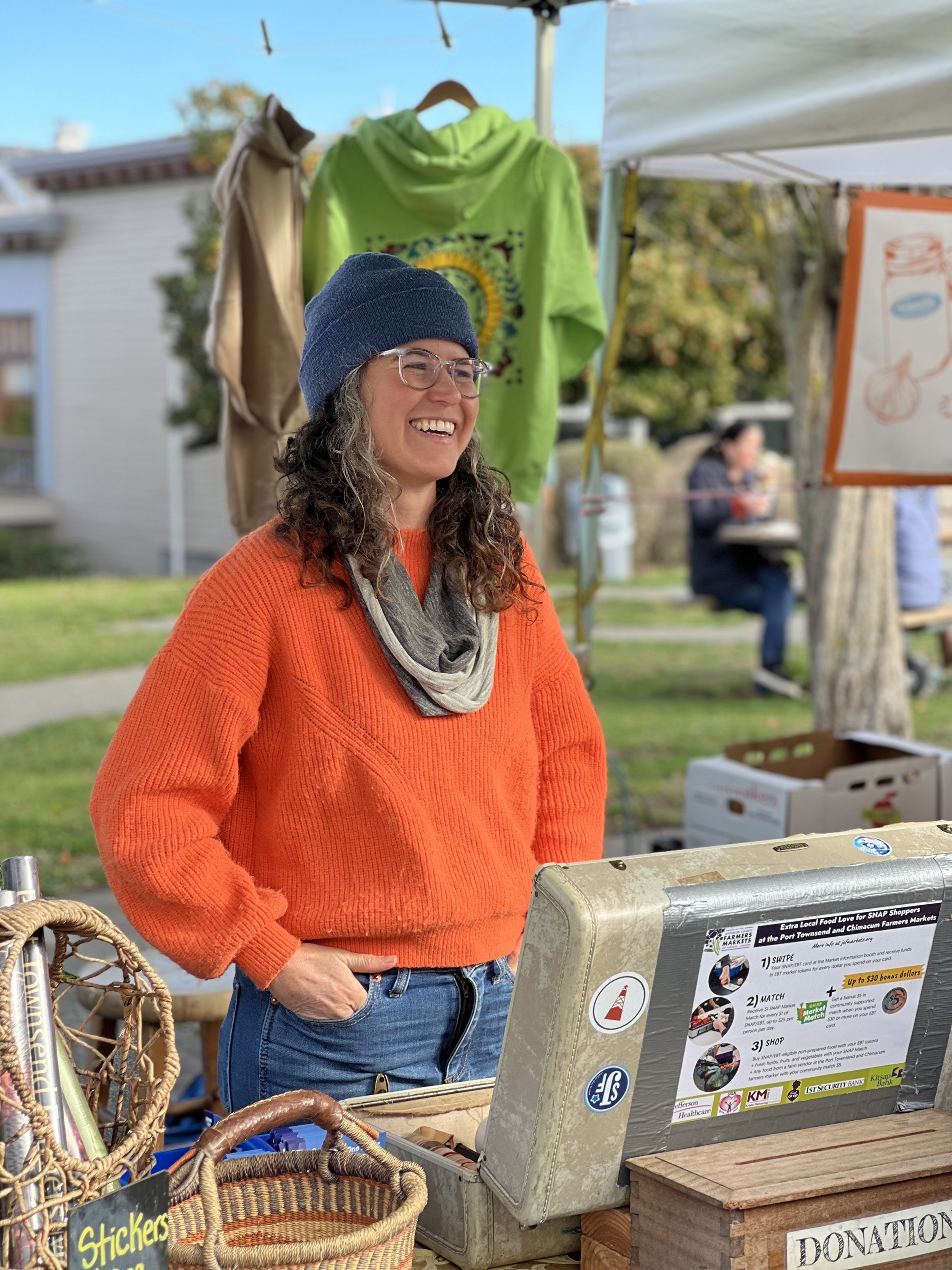 Amanda Milholland helps food insecure people navigate Farmers Market Programs at the market’s booth. Photo by Libby Pratt