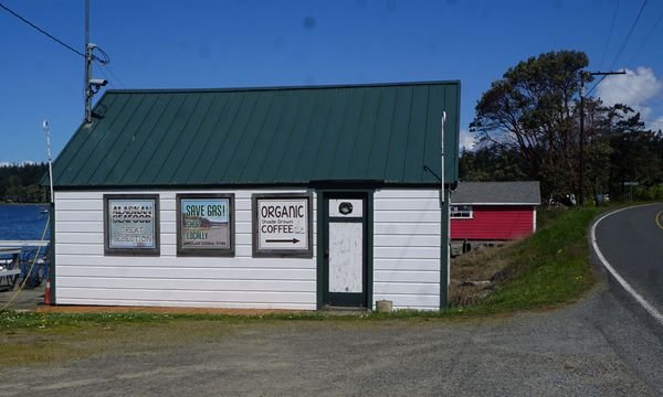 While the store has been closed since late 2020, signs on an adjacent building advertising its wares have remained intact.