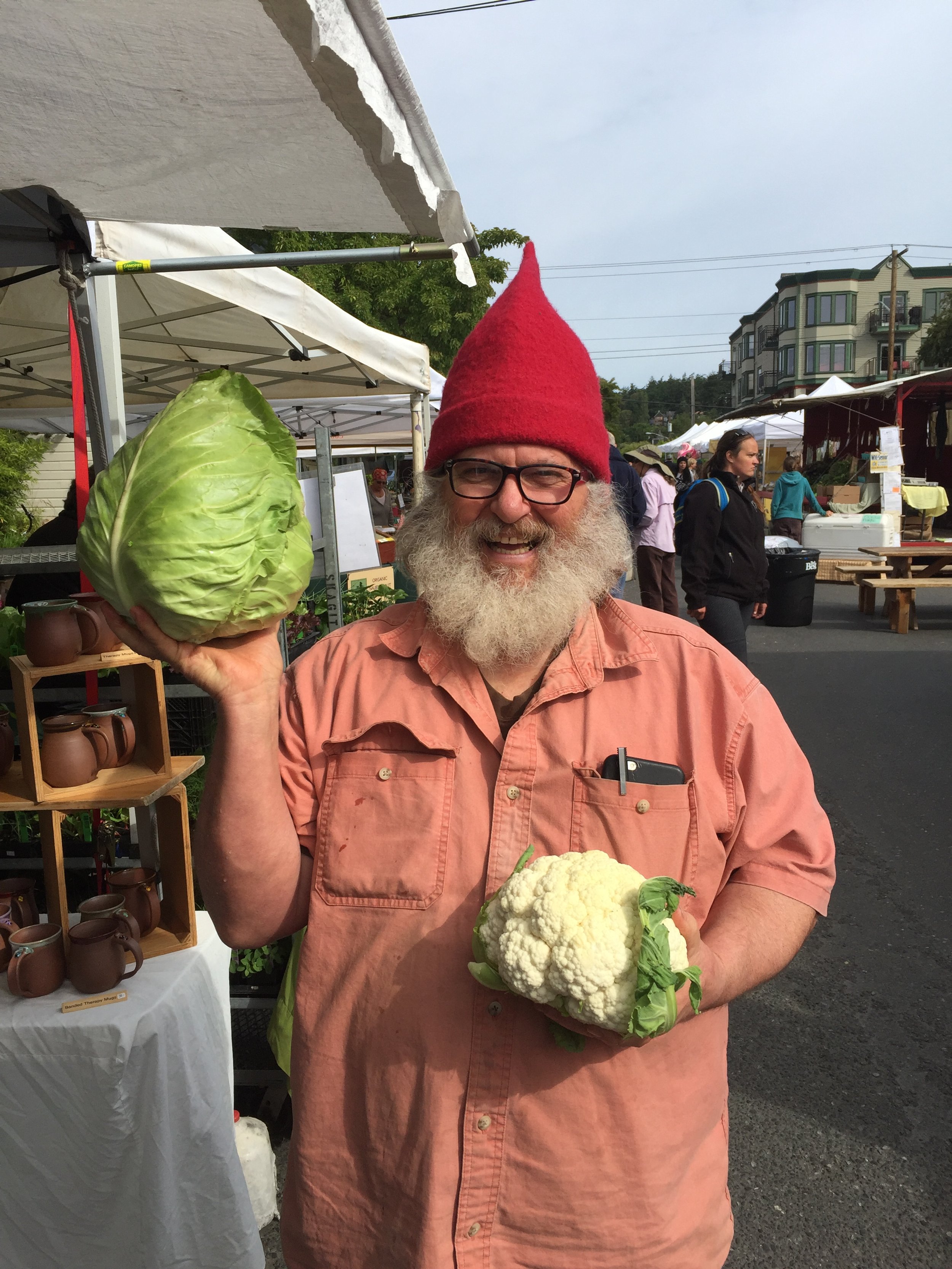   Huffman displays his wares, and his excellent sense of humor, at the Port Townsend Farmer’s Market. Photo curtesy of Laughin’Gnome Pottery  