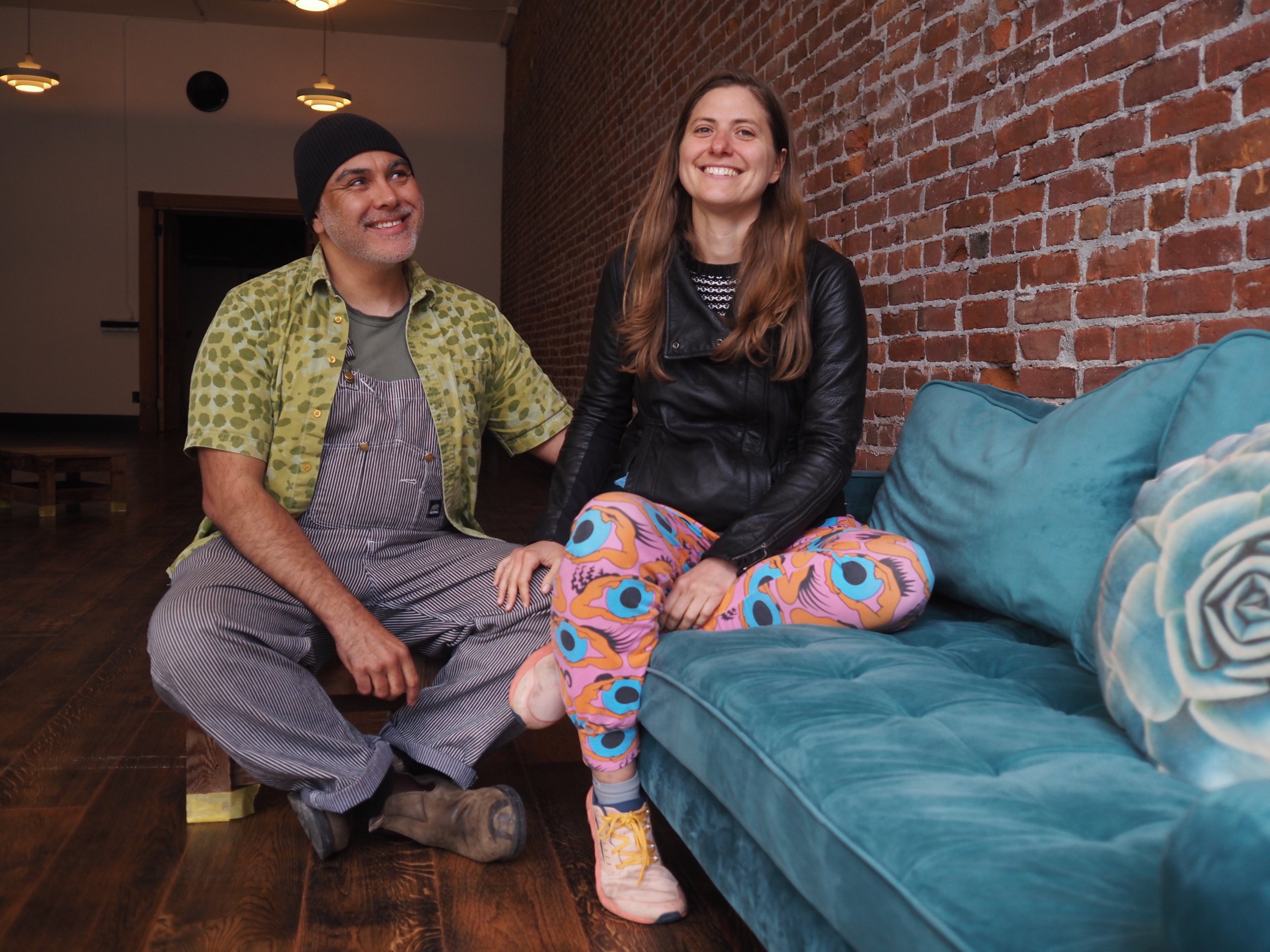   Pablo and Maria Qamara enjoy a moment on one of the couches they hope to fill their gathering space with. Beacon photo by Derek Firenze  
