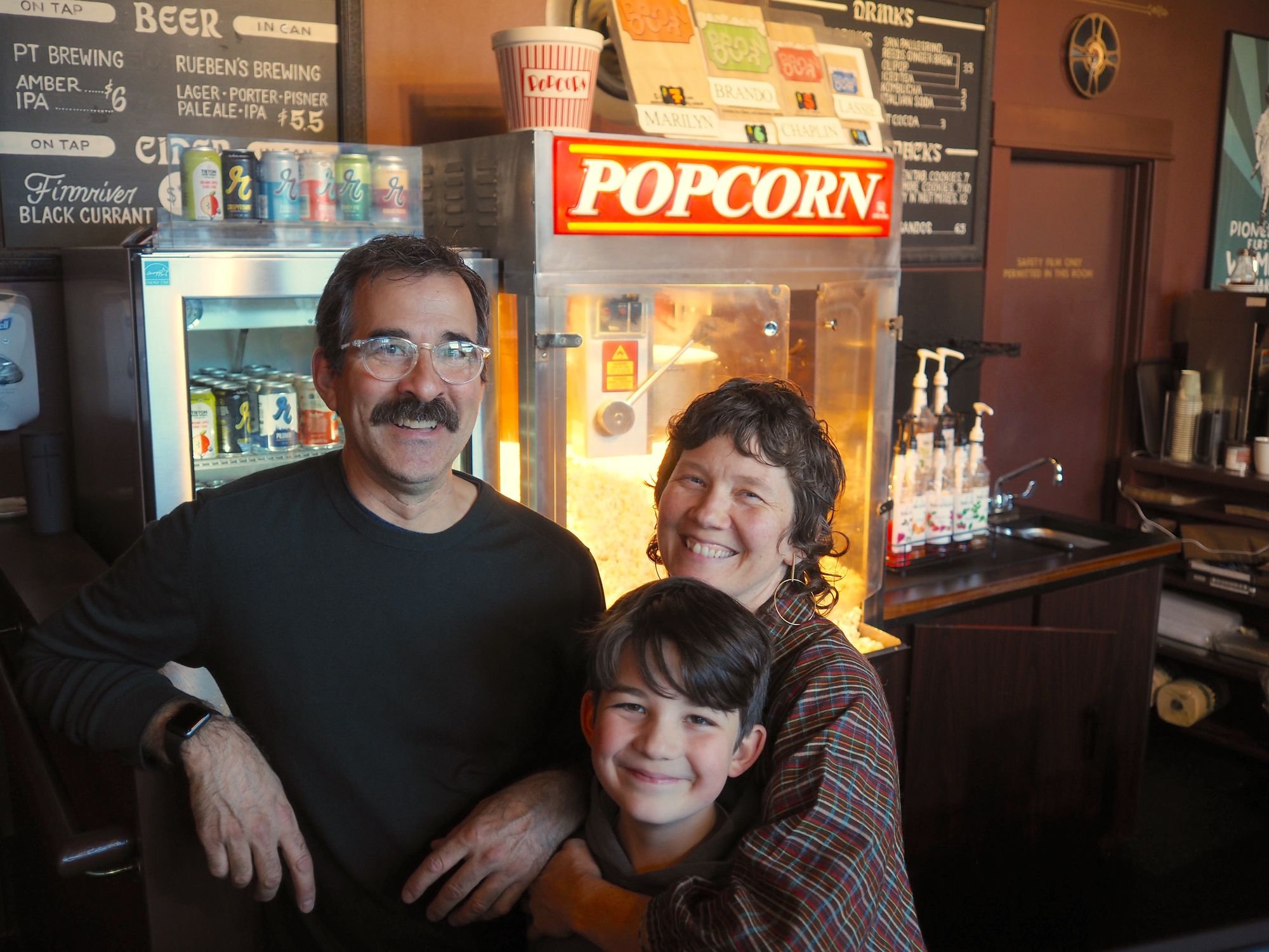   Rose Theatre owners Michael D'Alessandro and George Marie with their youngest son Emile, age 9. Photo by Derek Firenze  