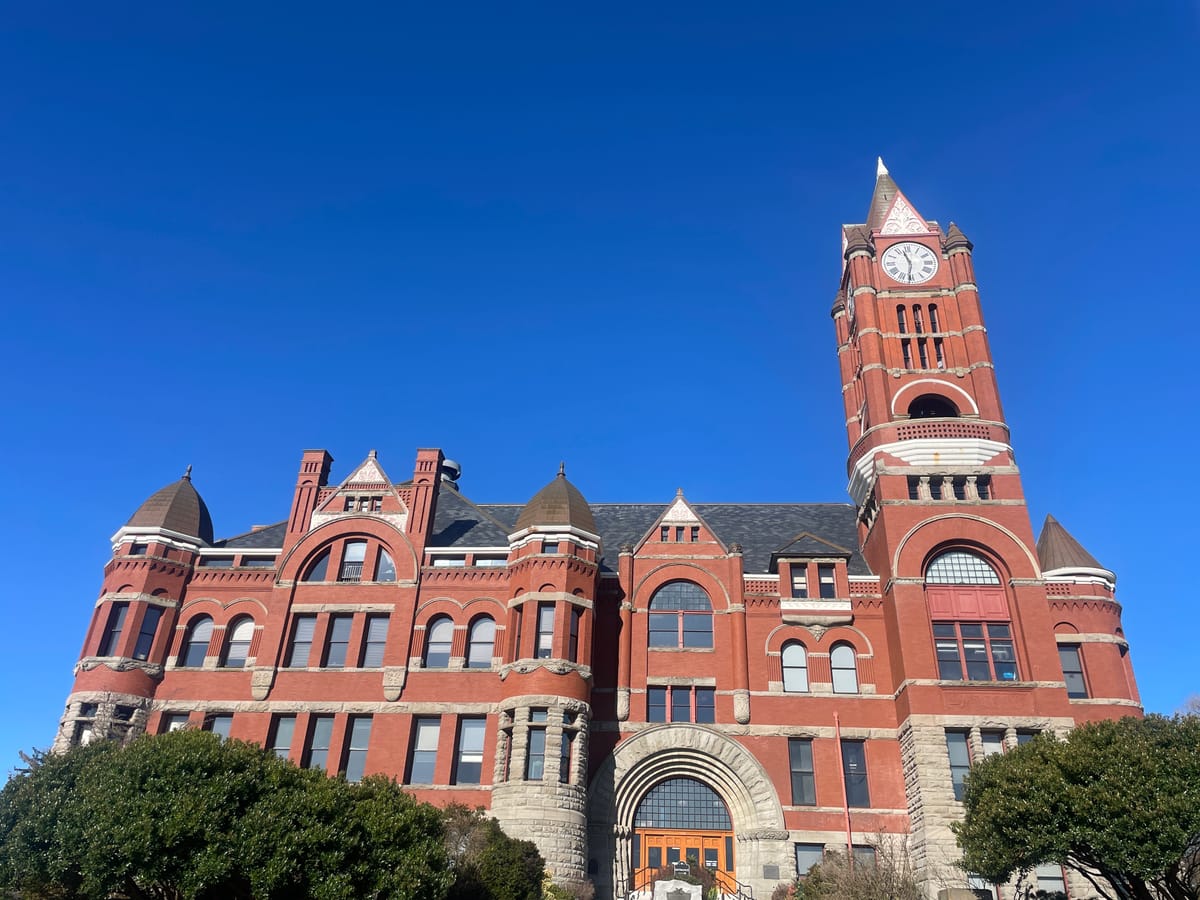 Jefferson County Courthouse, a large red brick building with a clocktower on the right side