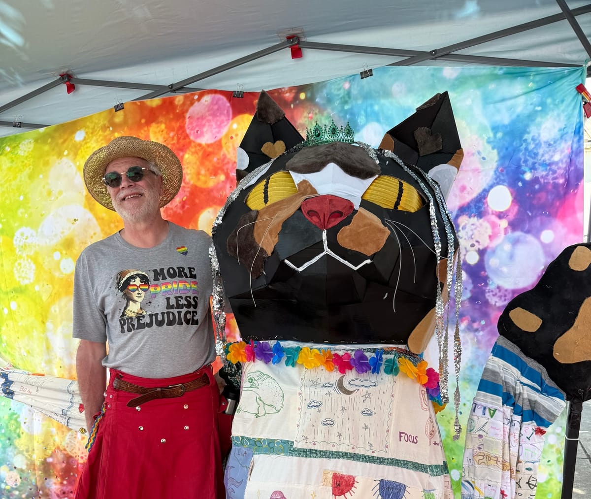 A jumbo cat puppet and artist Thaddeus Jurczynski to the left