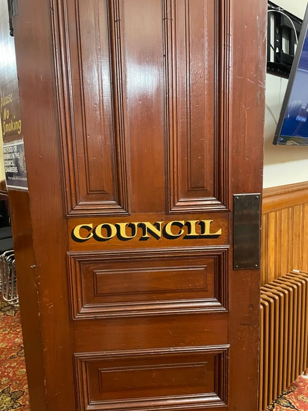 Port Townsend City Council Chamber door, a large brown wooden door